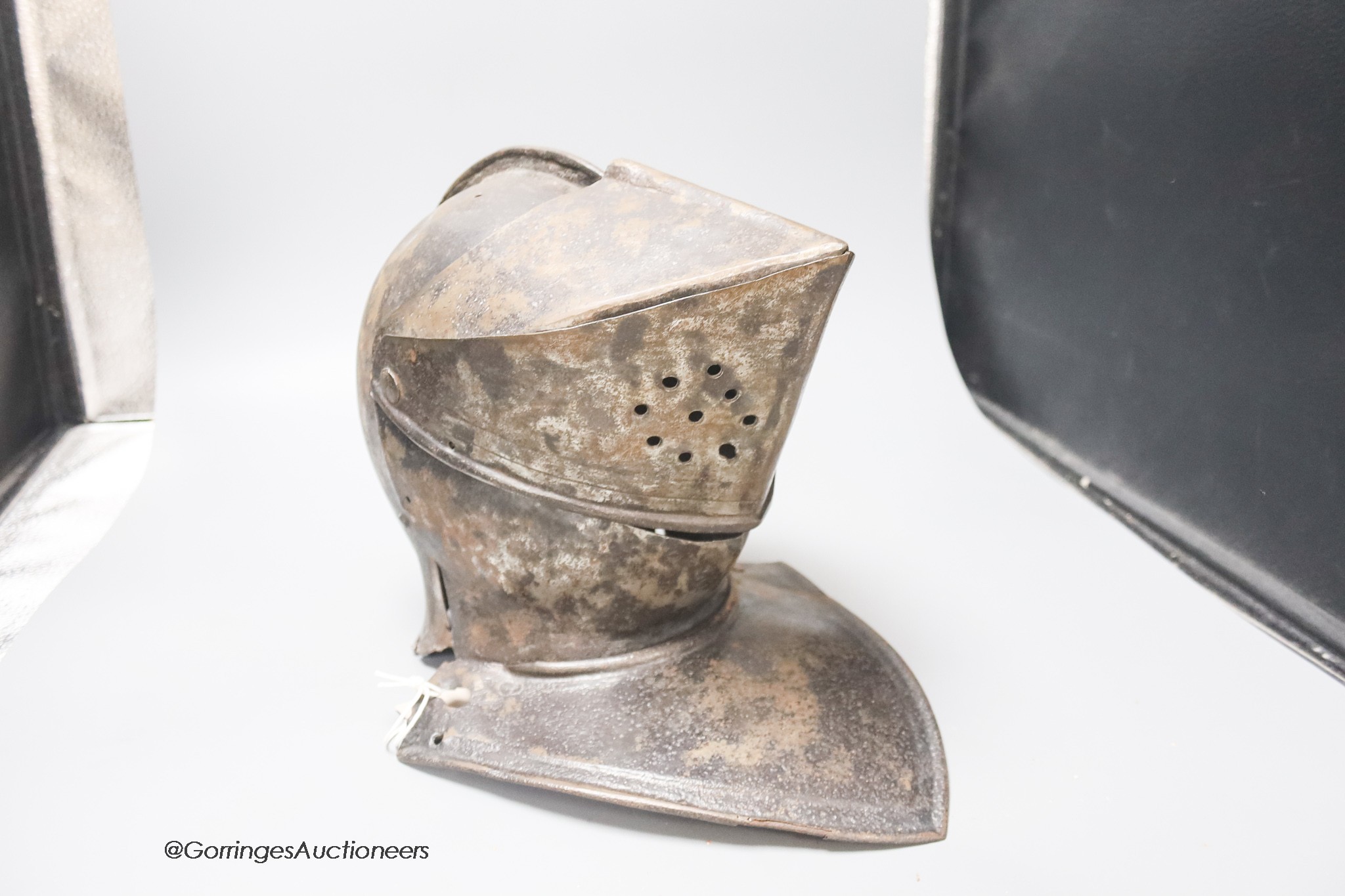 A 17th century iron close helmet, height 28cm approx.